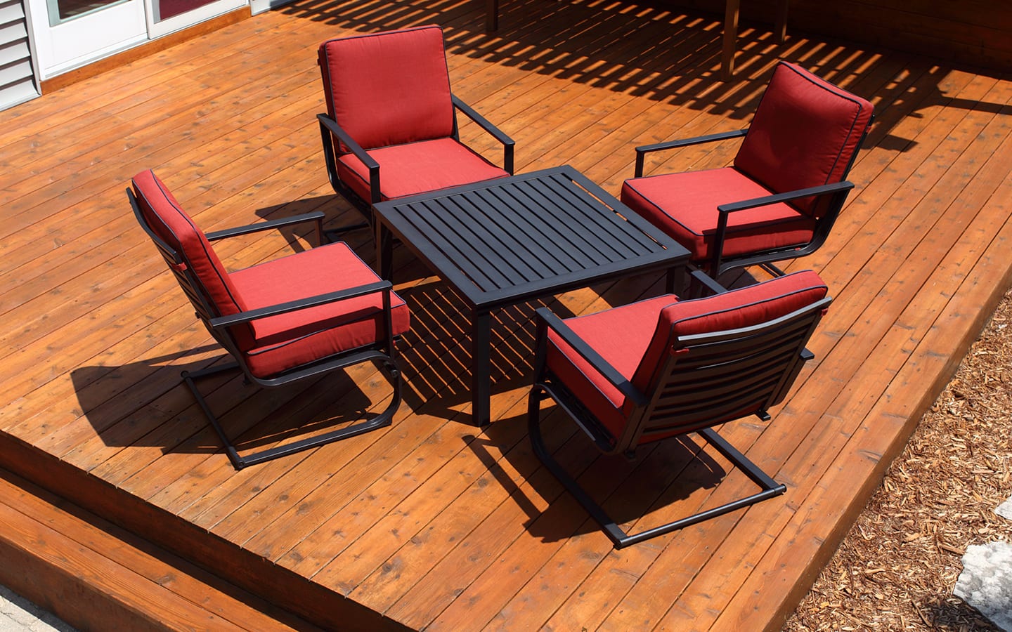 A clean, sealed deck with patio furniture