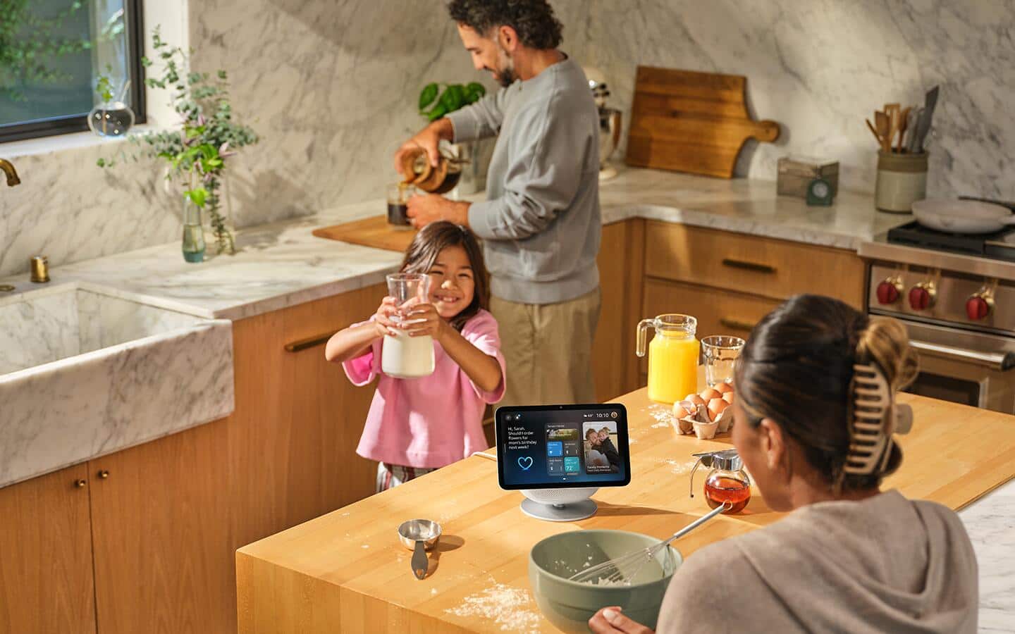 A family cooks in a kitchen with the help of a smart display. A family cooks in a kitchen with the help of a smart display.