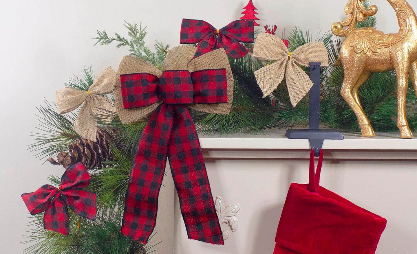 Garland with bows hangs on a mantel. Garland with bows hangs on a mantel.