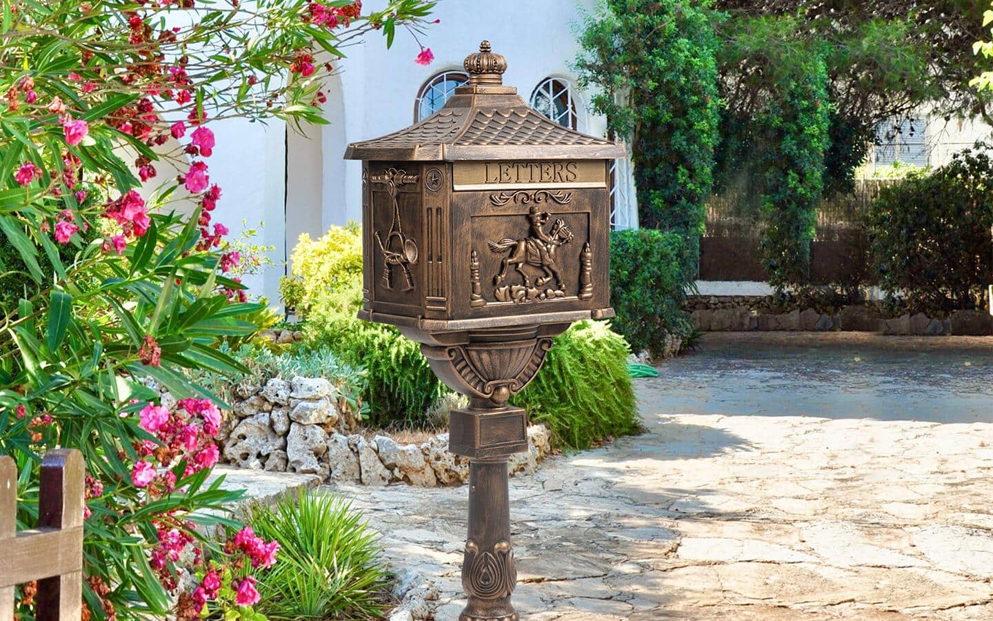 A brass mailbox featuring an ornate design. A brass mailbox featuring an ornate design.