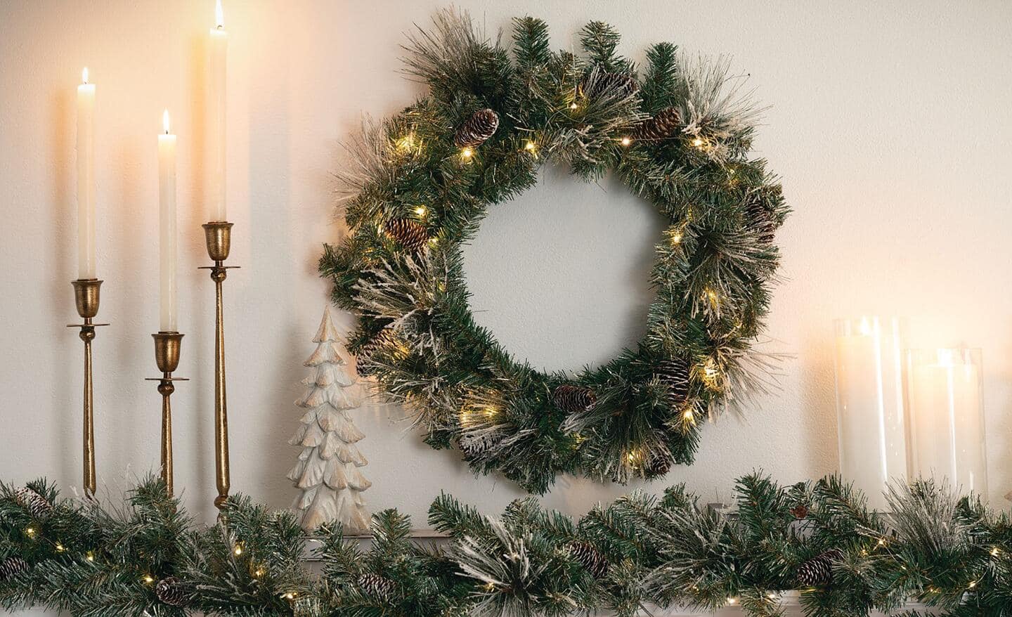 A pre-lit wreath above a mantel. A pre-lit wreath above a mantel.