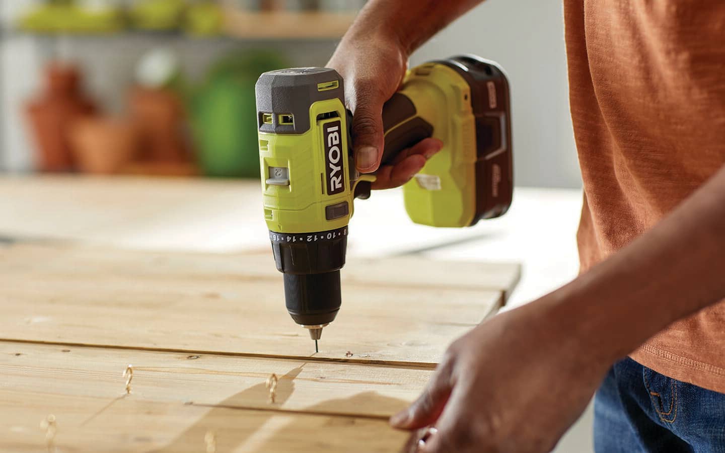 Someone drilling holes in a Christmas craft board.