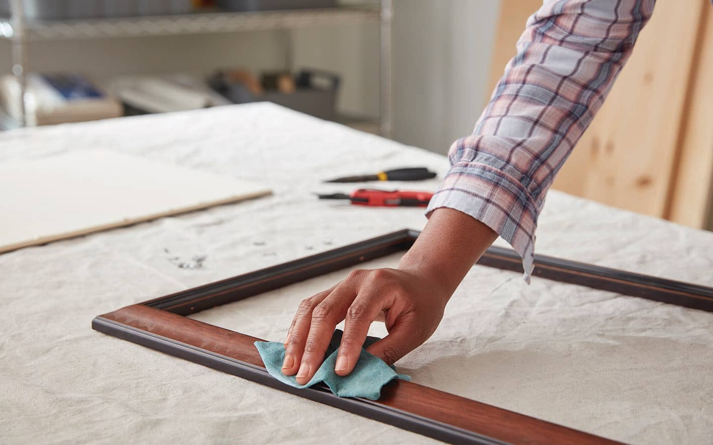 A person cleans a frame with a shop cloth. A person cleans a frame with a shop cloth.