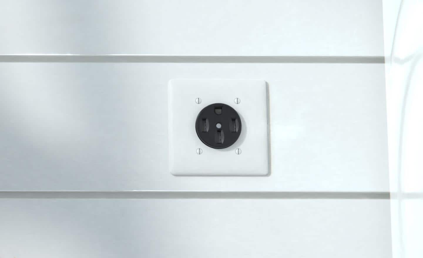 A 50-amp receptacle installed on a laundry room wall.