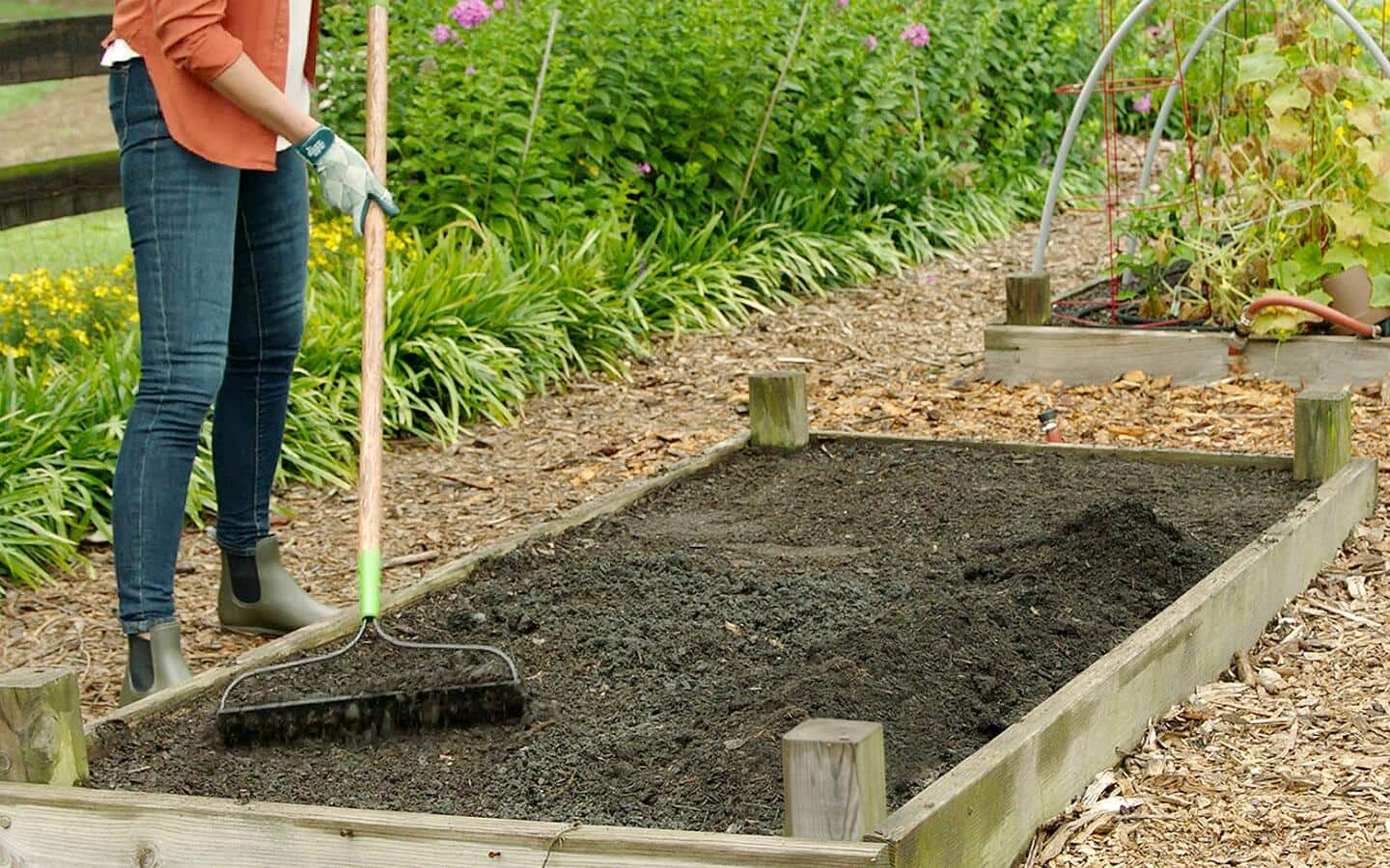 Someone raking a new garden bed. Someone raking a new garden bed.