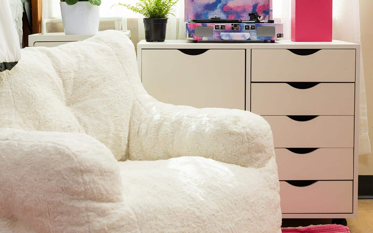 A comfortable easy chair placed in front of a stylish multi-drawer storage unit. A comfortable easy chair placed in front of a stylish multi-drawer storage unit.