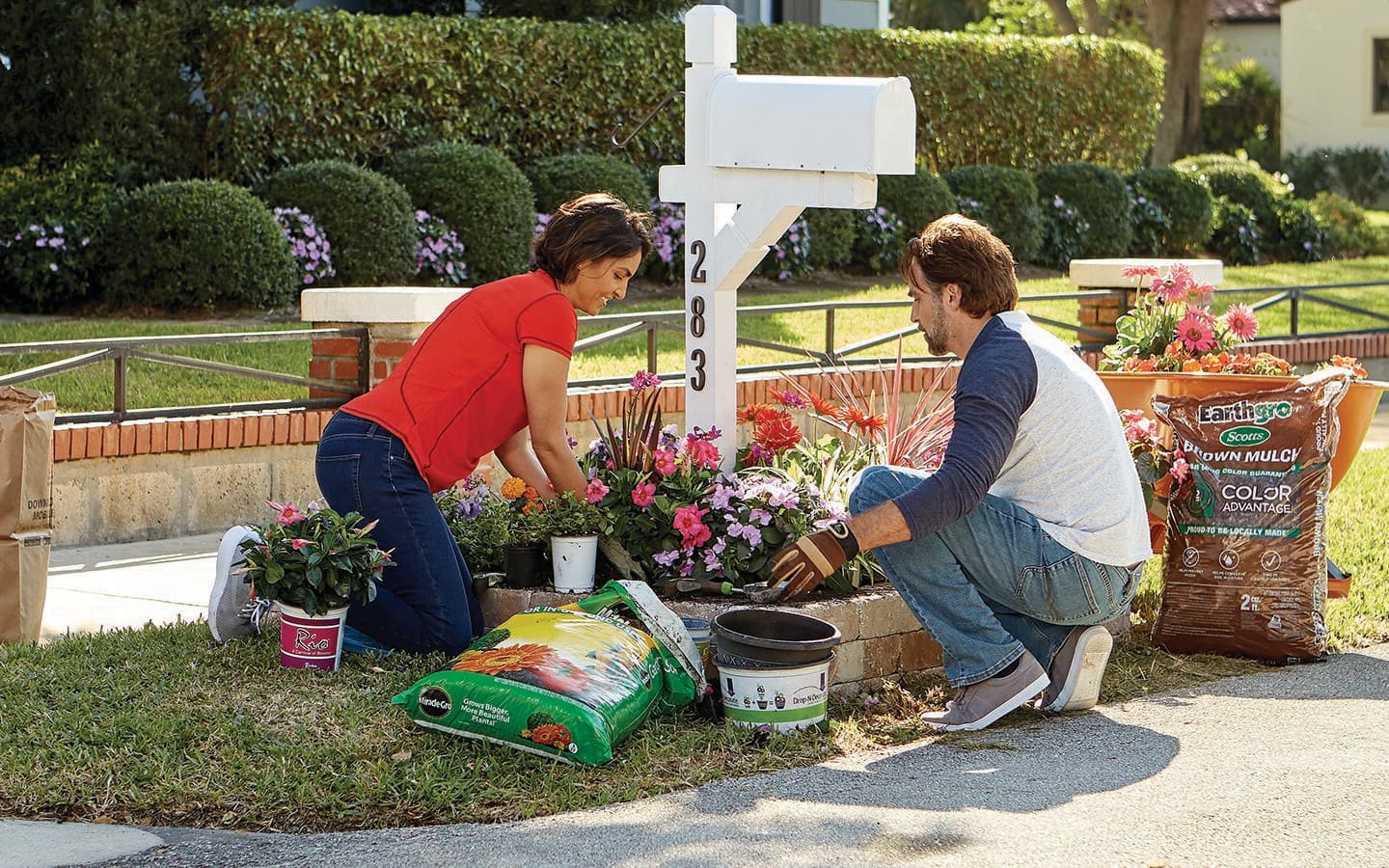 Homeowners planting around their curbside mailbox. Homeowners planting around their curbside mailbox.