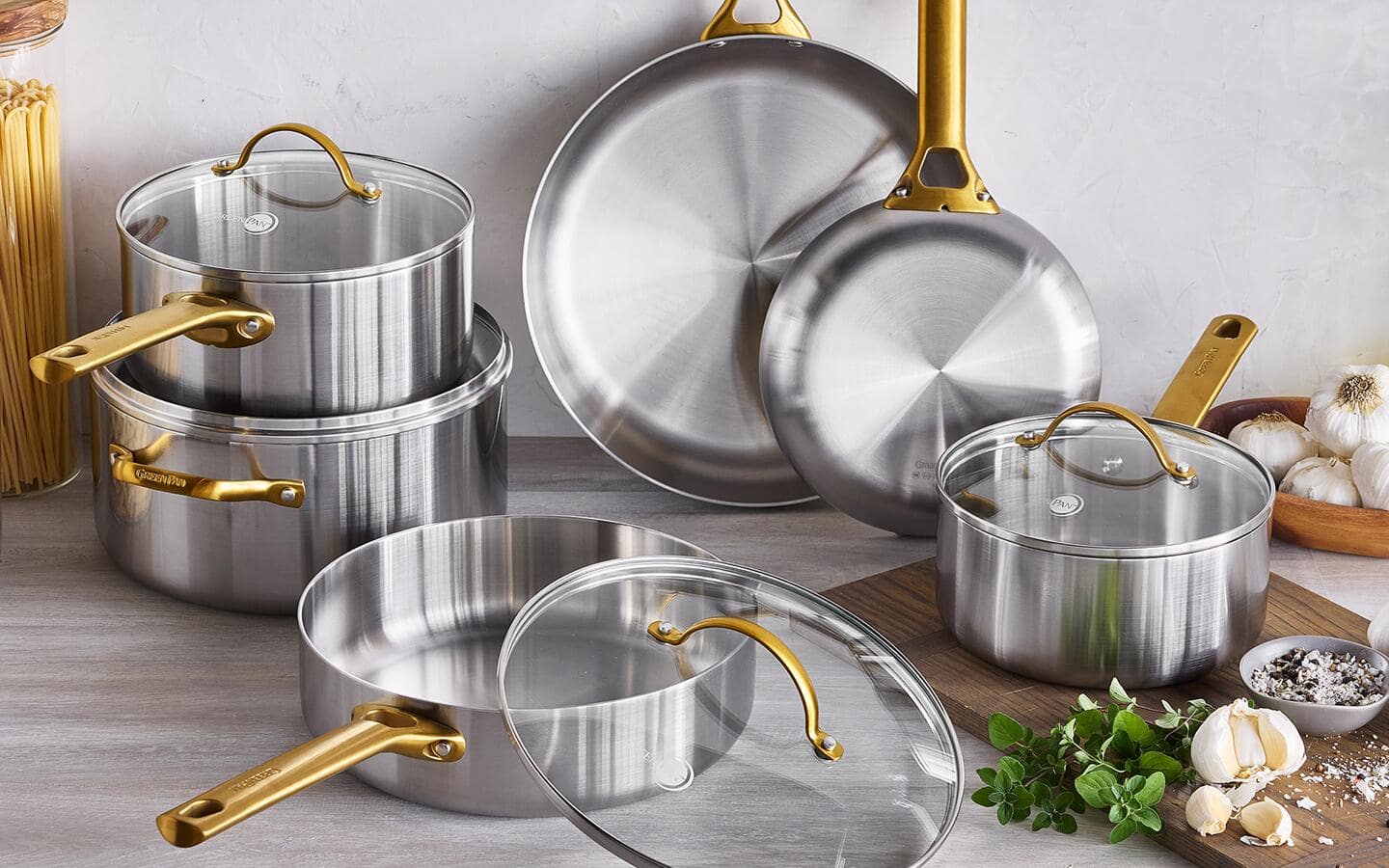 A stainless steel cookware set on a counter.