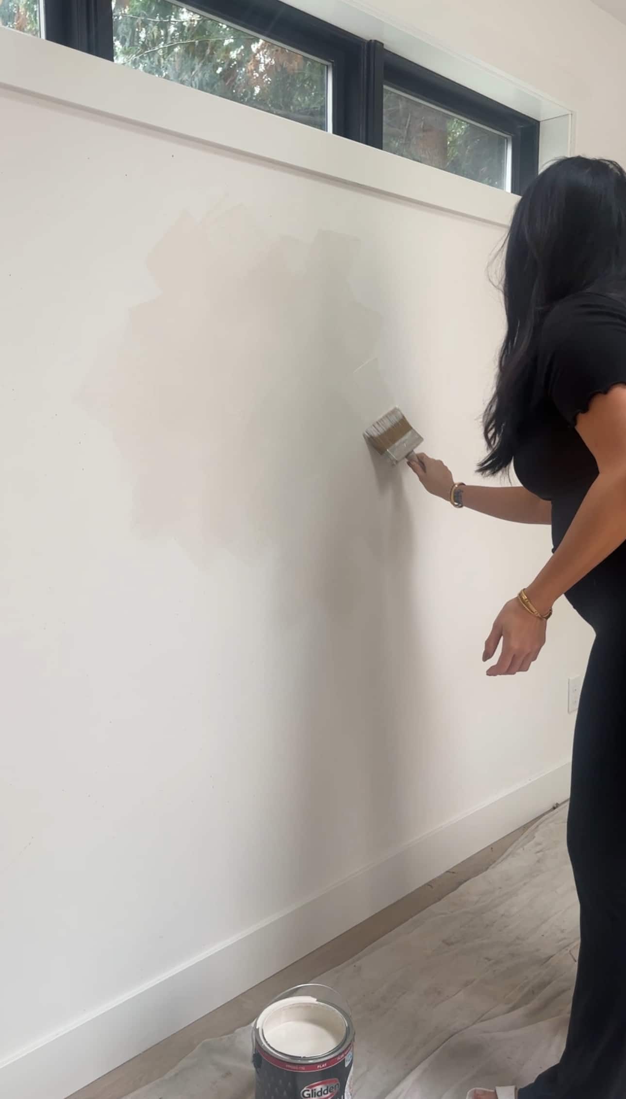 Sabrina painting her wall