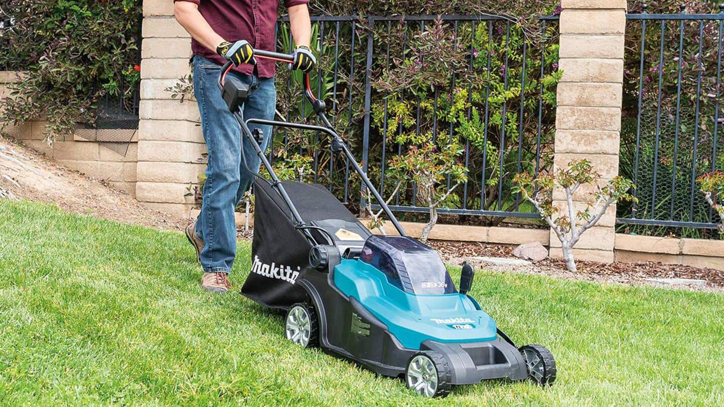 A lawn is being mowed with a battery powered push lawn mower.