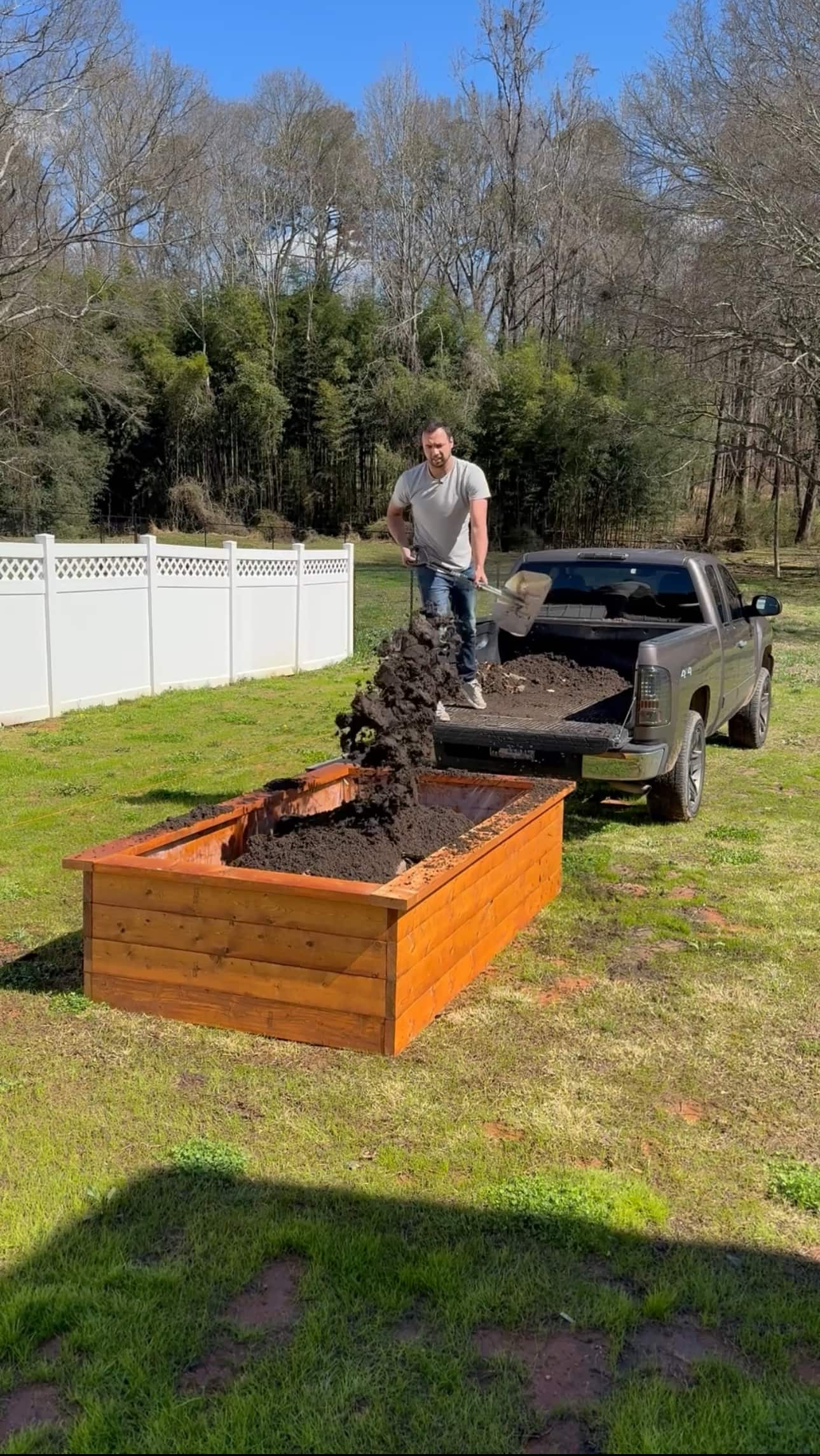 Clayton fills his assembled raised garden bed