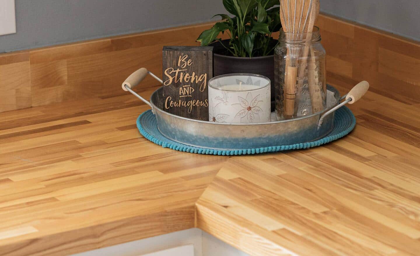 A butcher block countertop installed in the corner of a kitchen.