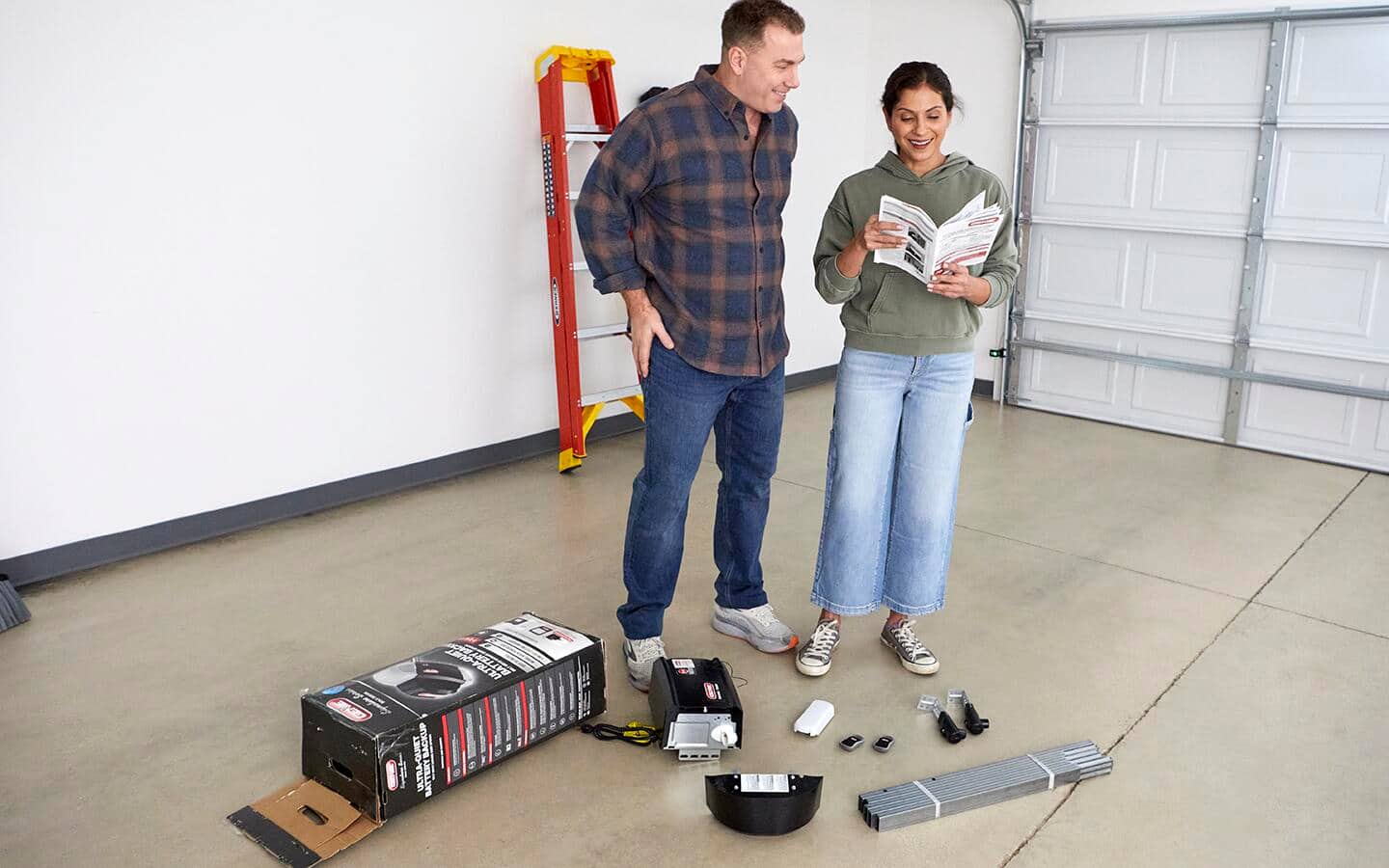 Two people read instructions for installing a smart garage door opener