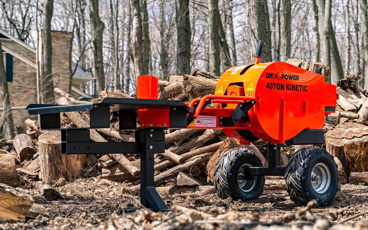 A 40-ton kinetic log splitter in a yard full of logs A 40-ton kinetic log splitter in a yard full of logs