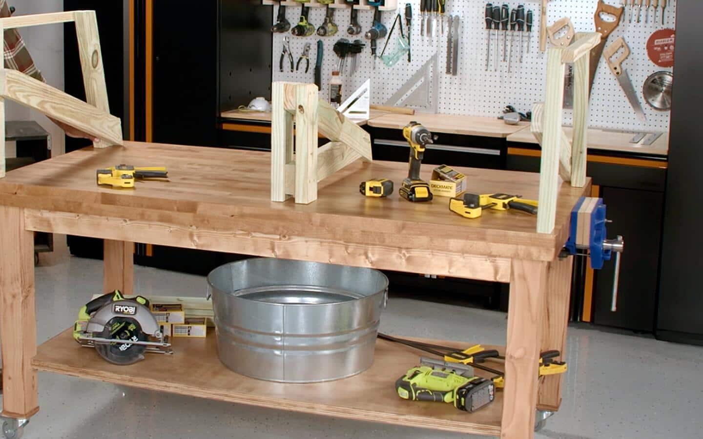 Assembled wooden sofa parts and various tools on a garage worktable. Assembled wooden sofa parts and various tools on a garage worktable.
