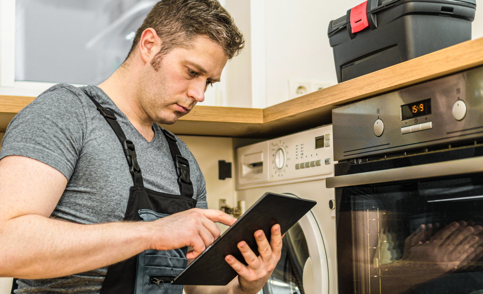 An electrician calculates a home’s electrical load on a tablet.