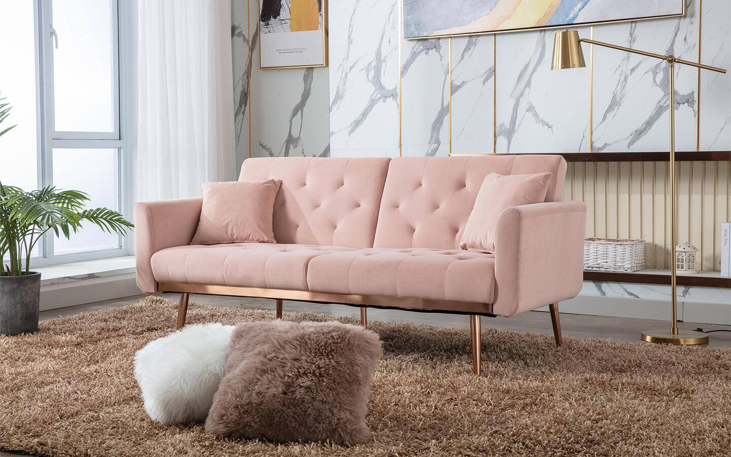 A pink sofa with metal legs in a modern living room.