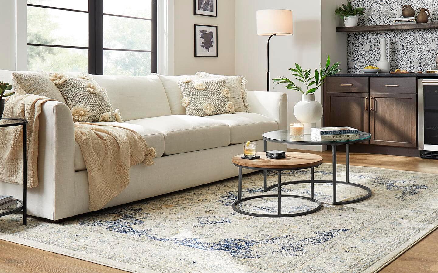 A living room with a couch and coffee tables.