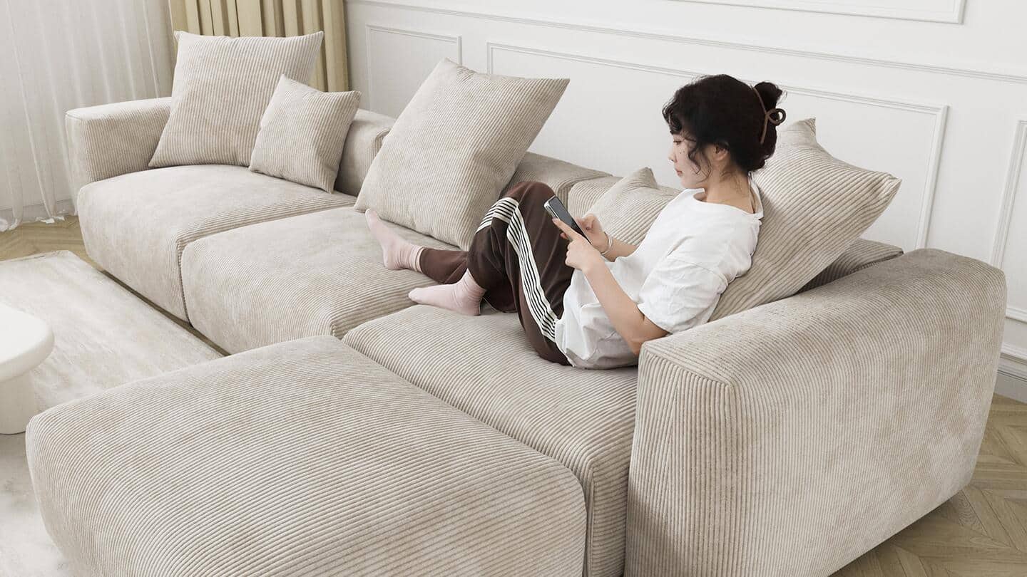 Someone sitting on a sectional sofa in a living room. Someone sitting on a sectional sofa in a living room.
