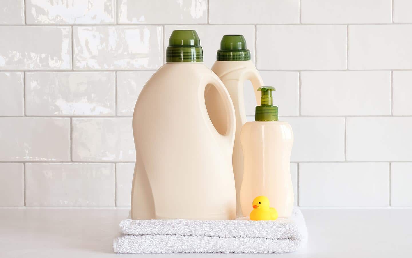 Bottles of shampoo, dish soap and detergent on a bathroom shelf. Bottles of shampoo, dish soap and detergent on a bathroom shelf.