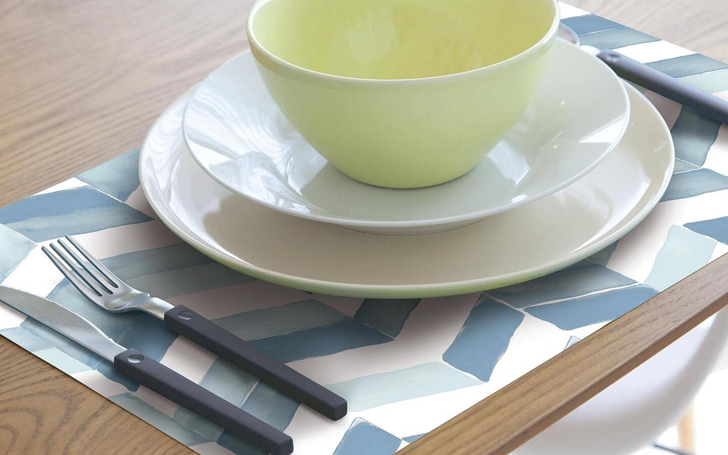 A place setting made with a DIY peel and stick wallpaper placemat. A place setting made with a DIY peel and stick wallpaper placemat.