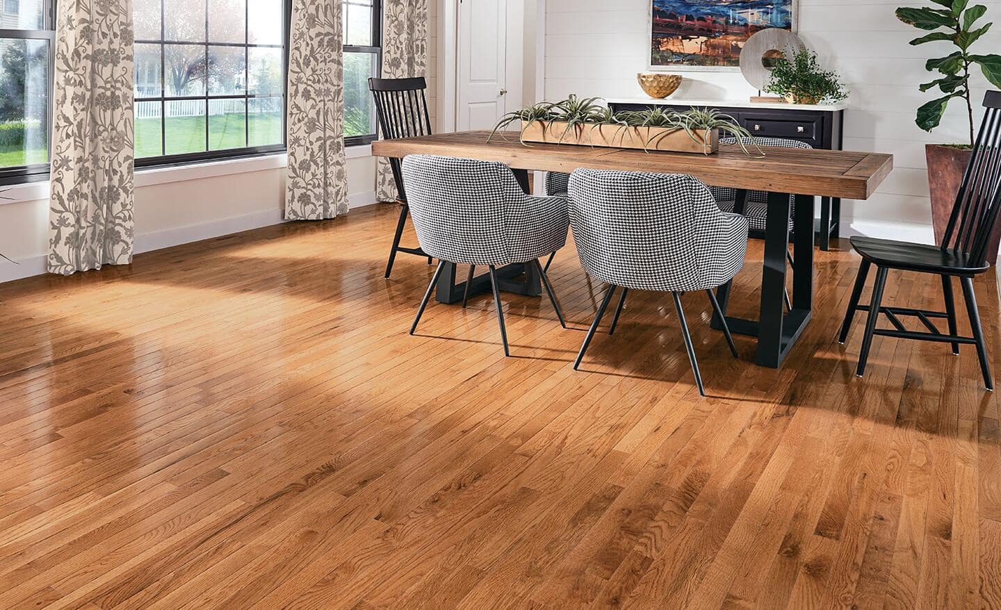 A dining room featuring a warm, hardwood floor.