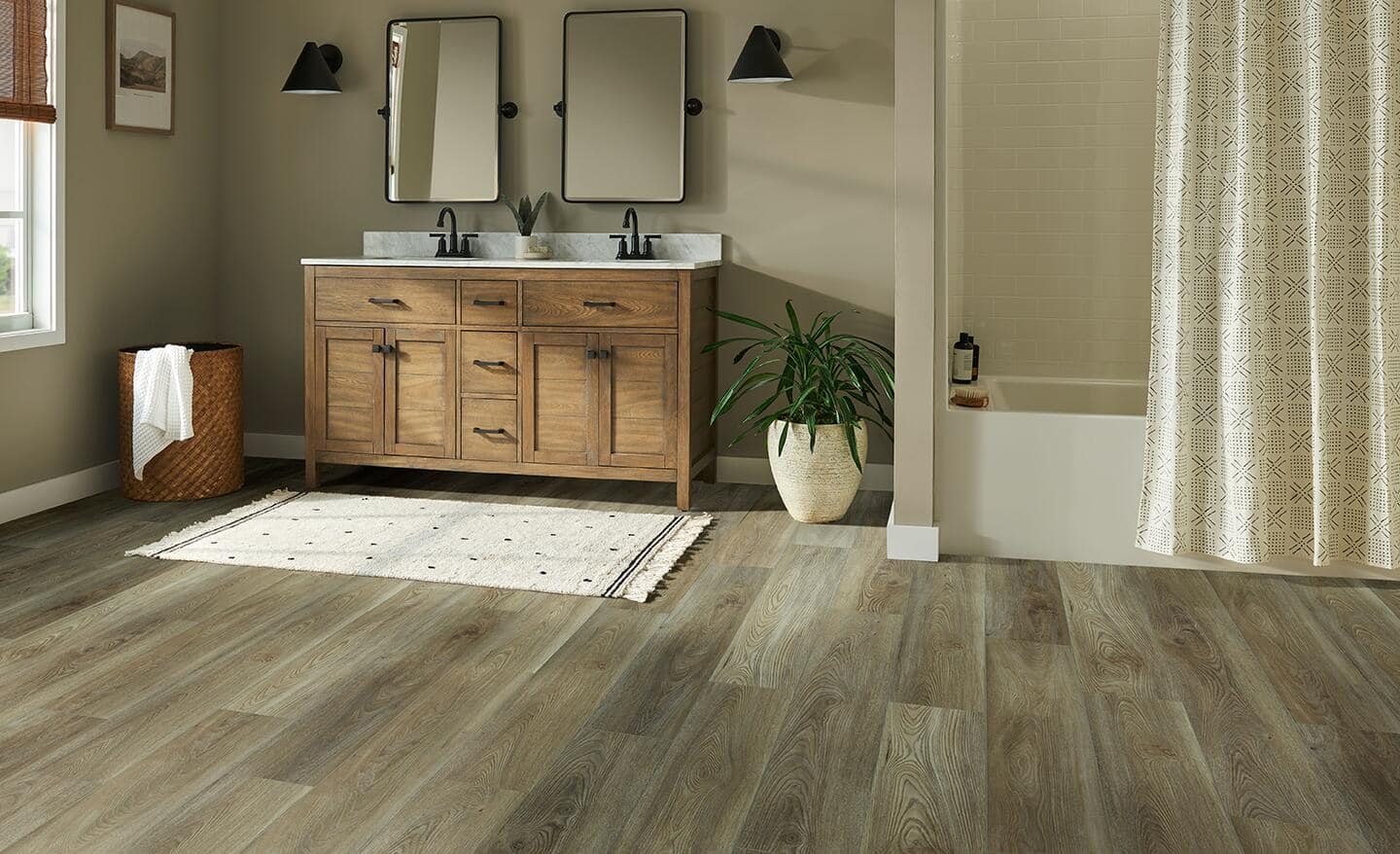 A well-lit bathroom with luxury vinyl plank flooring.