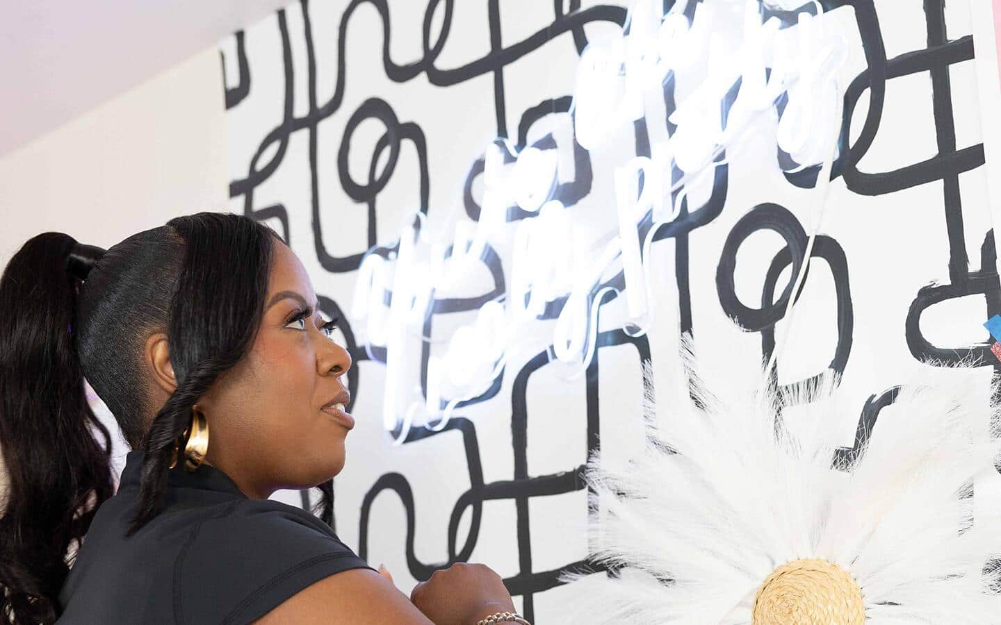 Student applying a bold, peel-and-stick wallpaper to a dorm wall. Student applying a bold, peel-and-stick wallpaper to a dorm wall.