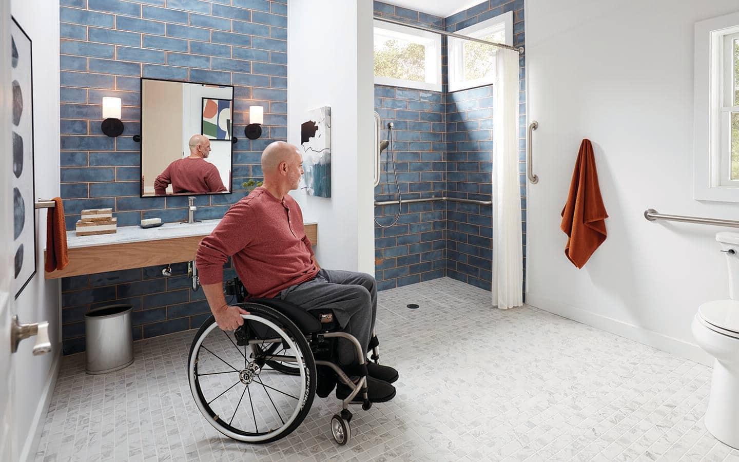 A man turns his wheelchair in a bathroom. A man turns his wheelchair in a bathroom.