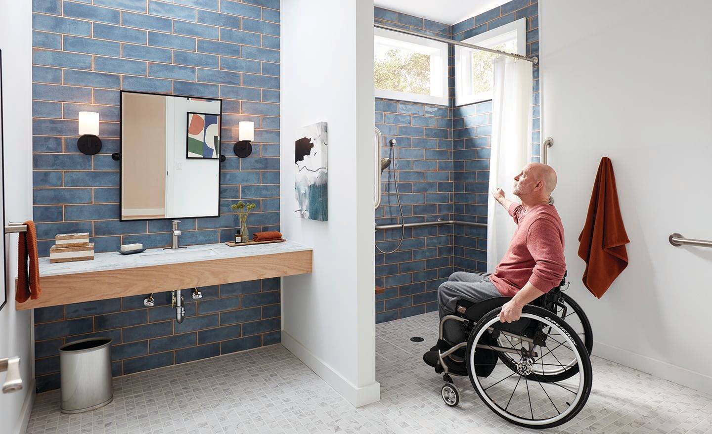 A man in a wheelchair looking at a barrier-free shower.