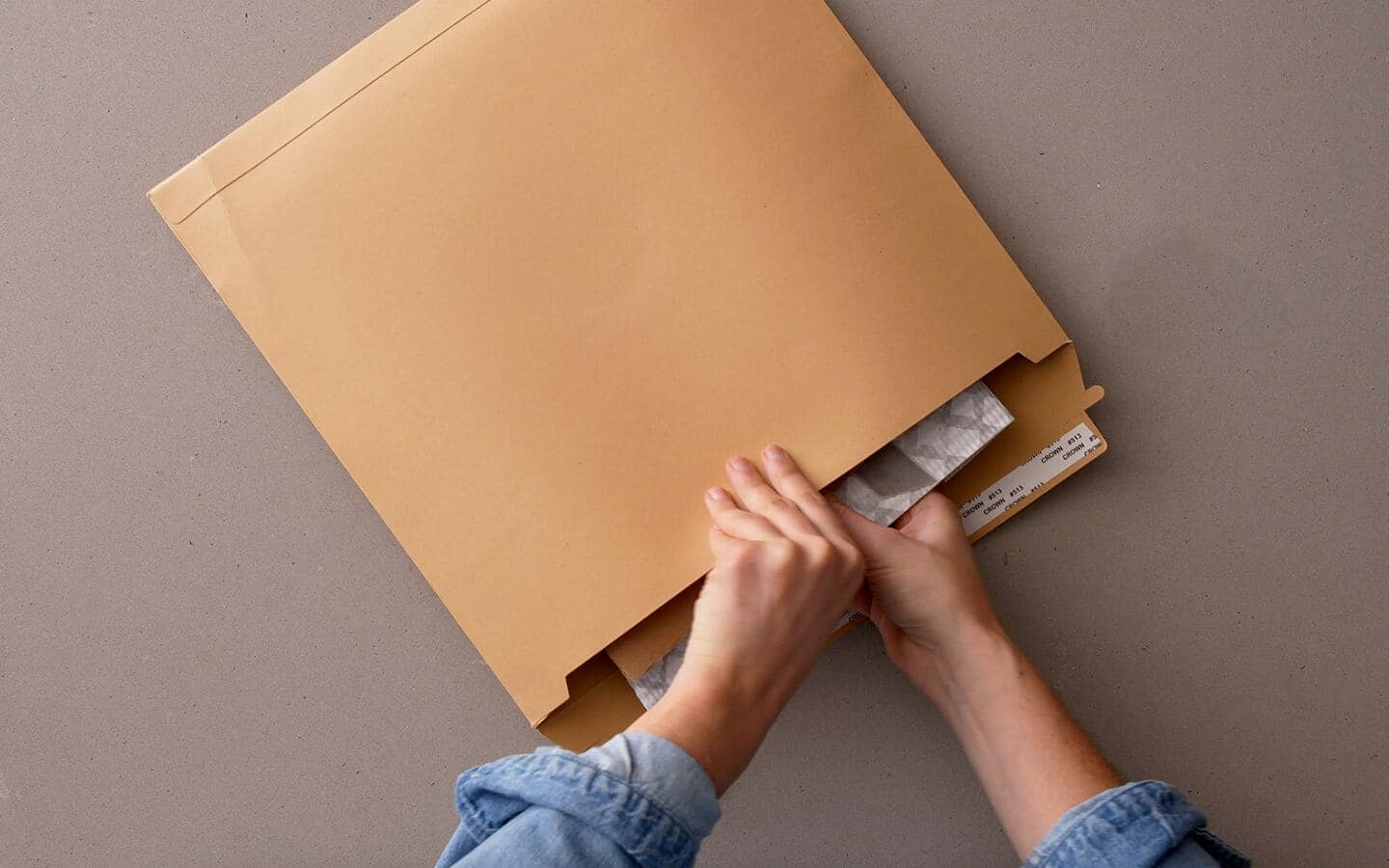 A wrapped DIY pouch is placed in a yellow shipping envelope.