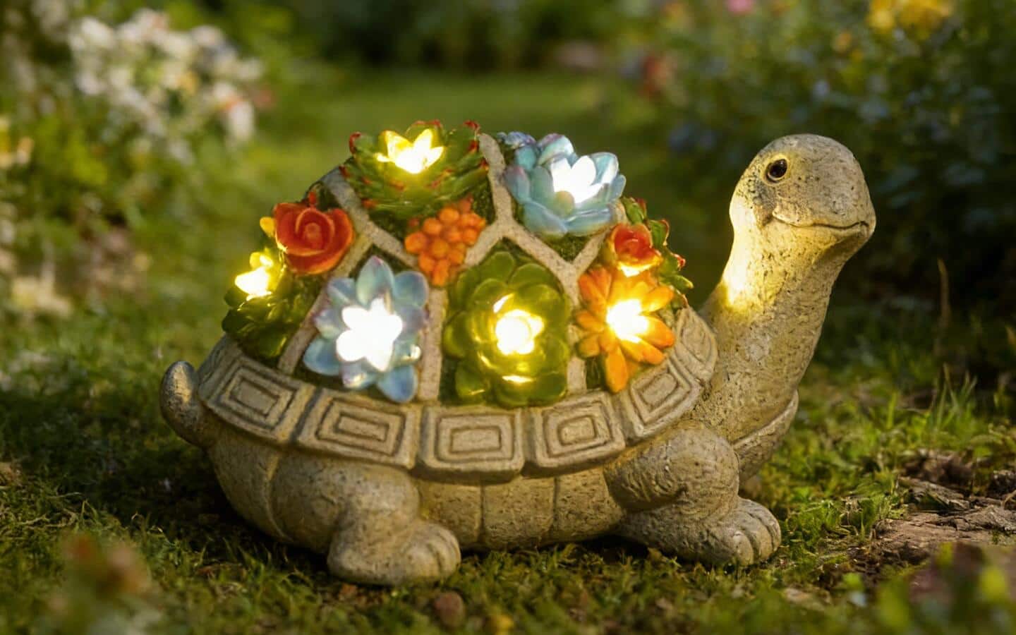 A stone tortoise featuring colorful flowers with lights.