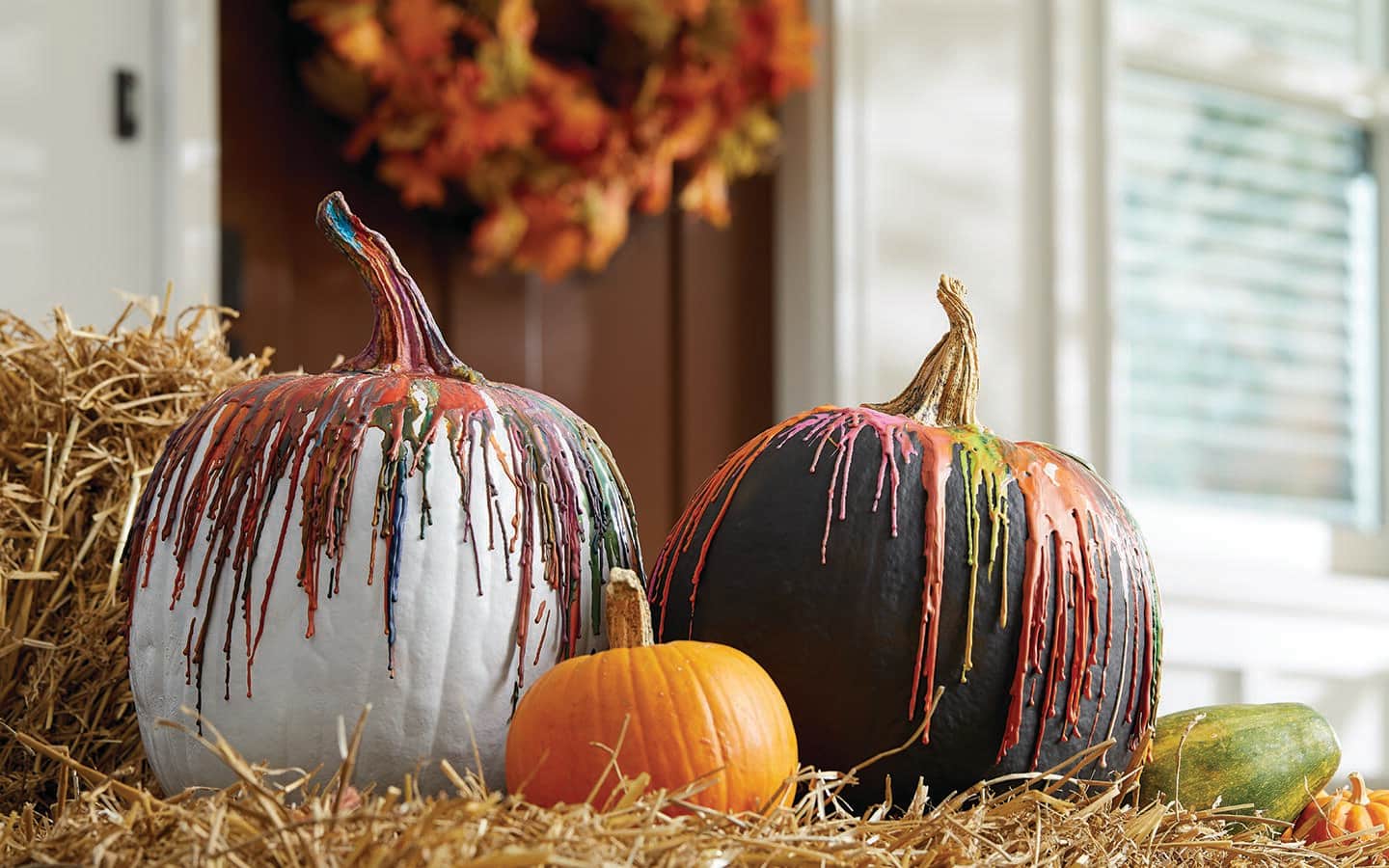 Pumpkins drizzled with colorful crayon wax.