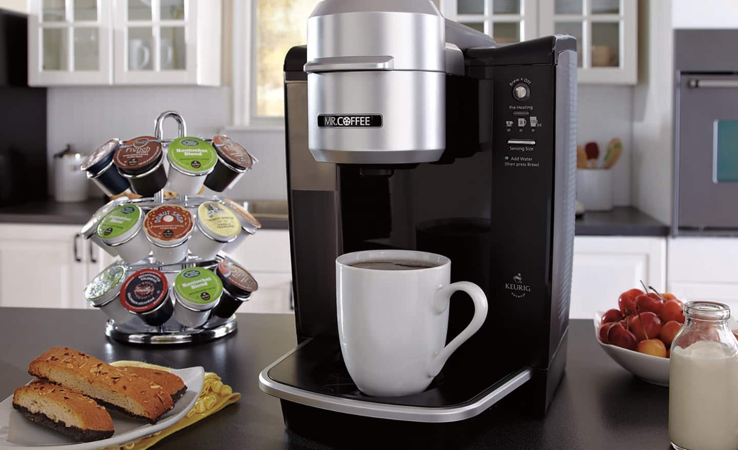 A coffee maker and a coffee cup in a kitchen A coffee maker and a coffee cup in a kitchen