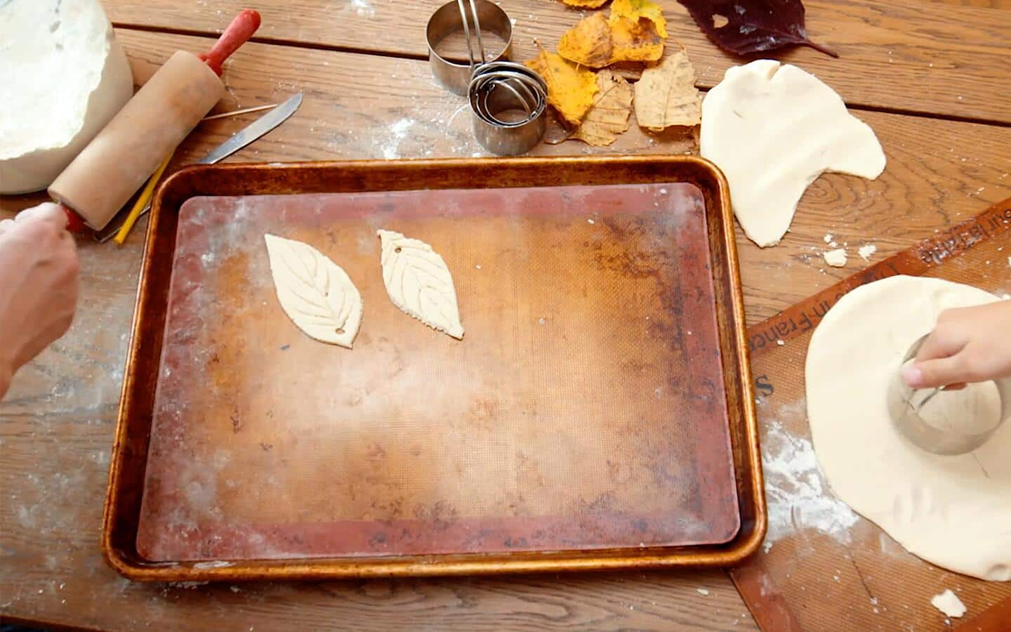 Leaf ornaments cut and laid on a baking tray.