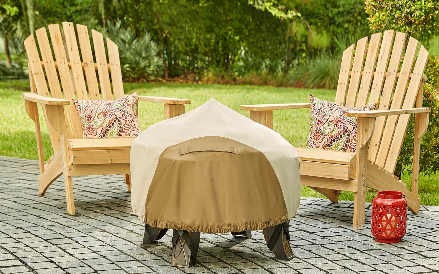 A fire pit is under a fitted cover to protect it from weather when not being used.
