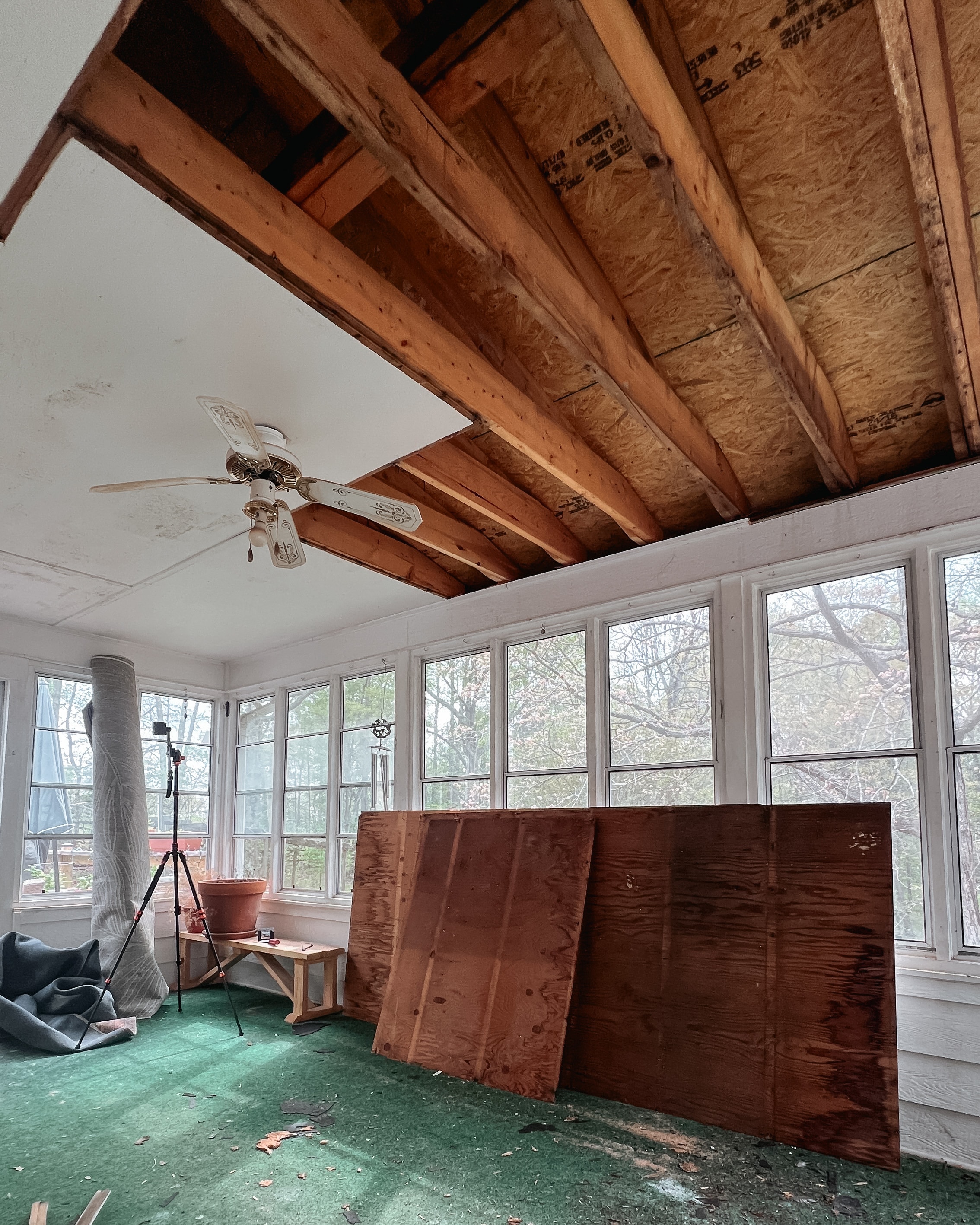 An unfinished ceiling with exposed boards