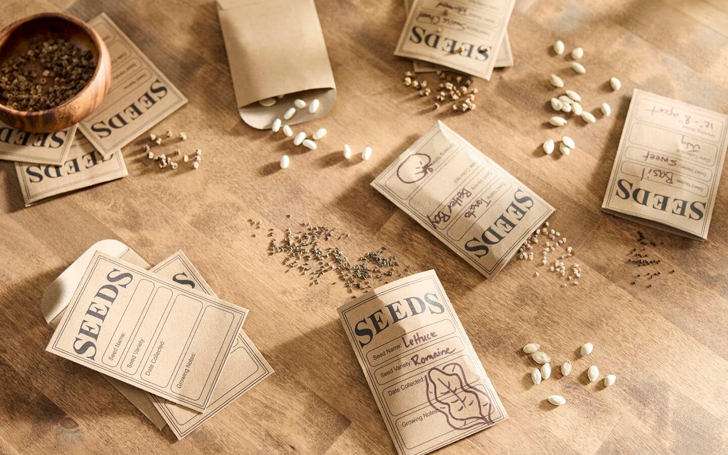 Seed packets opened with seeds spilling out on a table