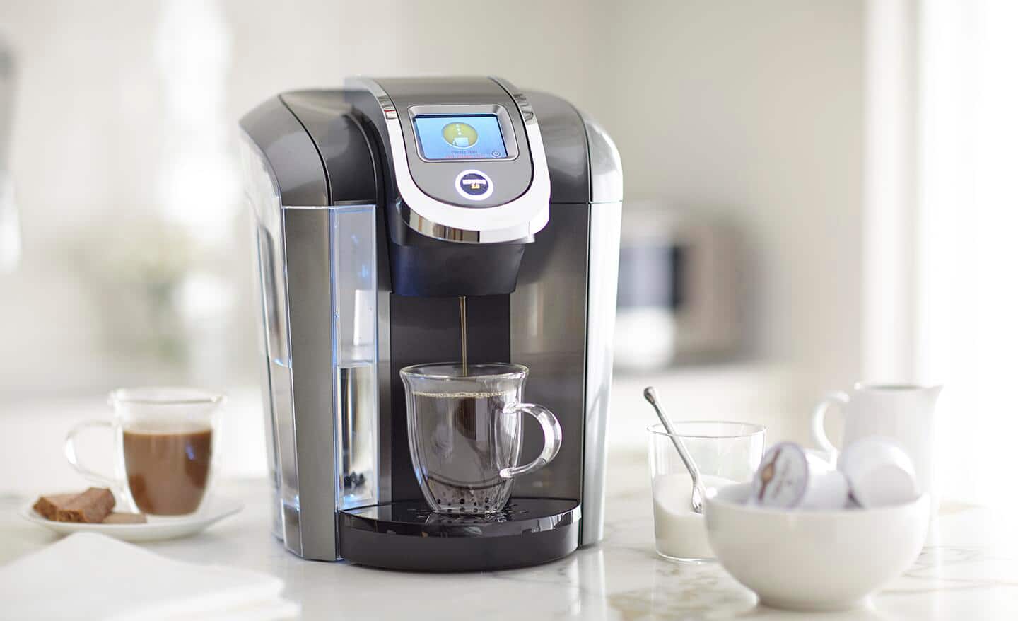 A cup of coffee being made from a single serve coffee maker. A cup of coffee being made from a single serve coffee maker.