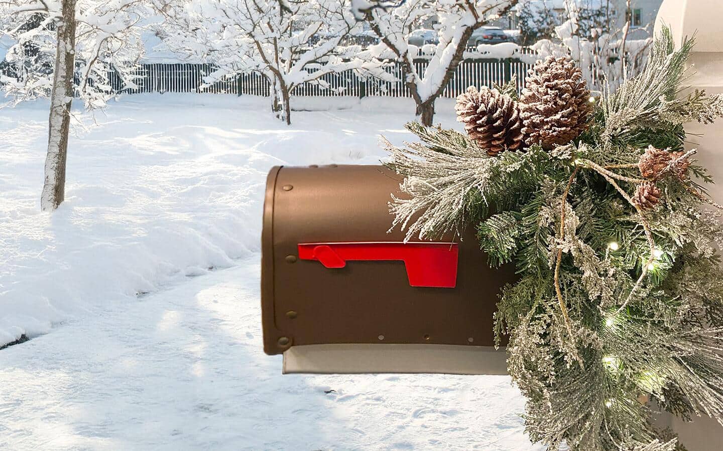 A mailbox decorated with evergreens and lights for the holidays. A mailbox decorated with evergreens and lights for the holidays.