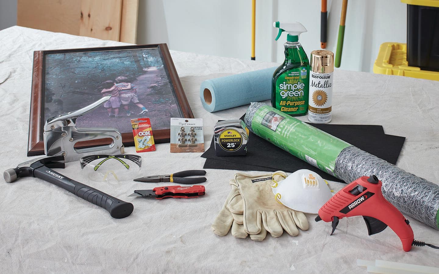 Tools and materials for chicken wire memo board sit on table. Tools and materials for chicken wire memo board sit on table.