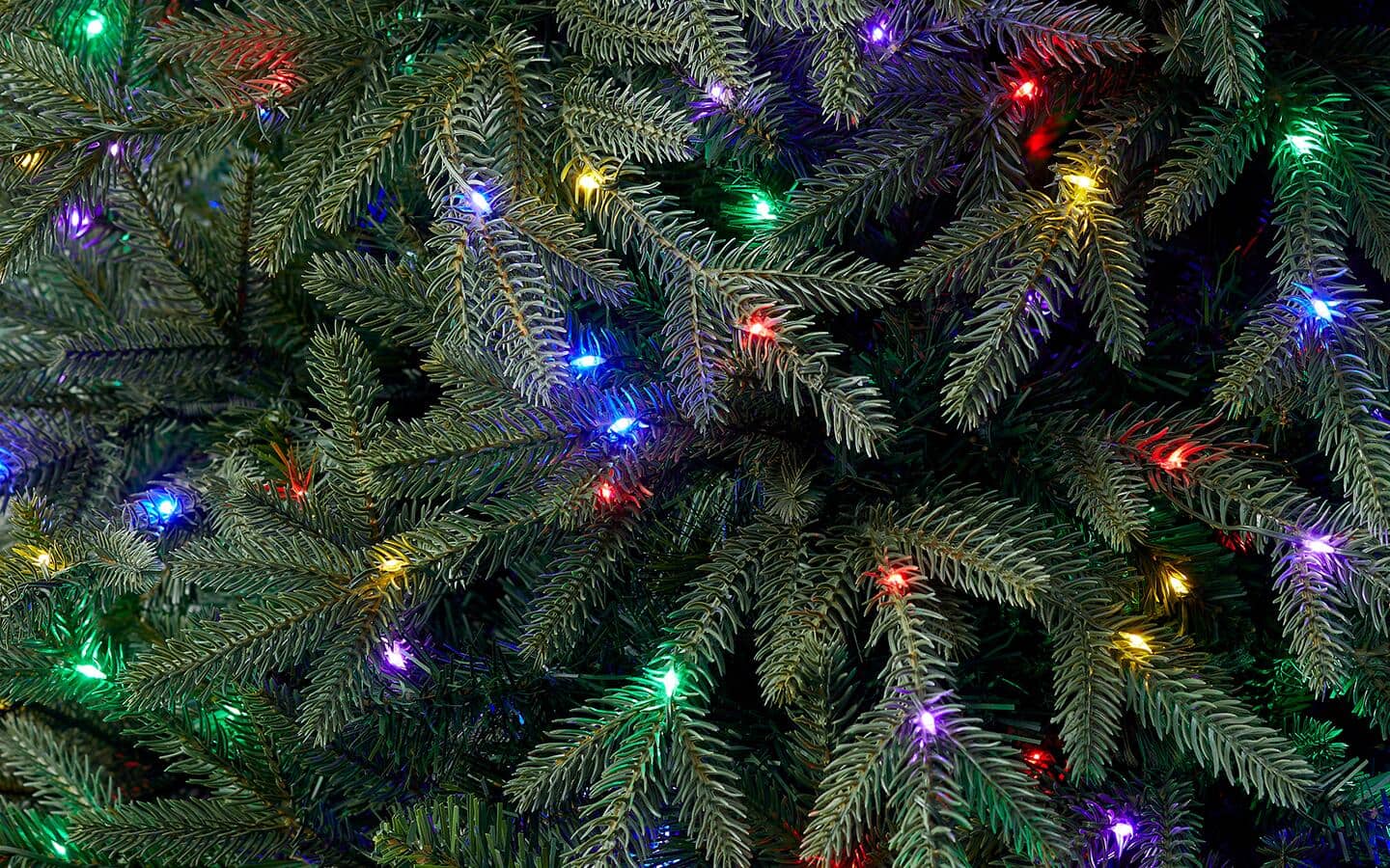 A close up of a pre-lit artificial Christmas tree.