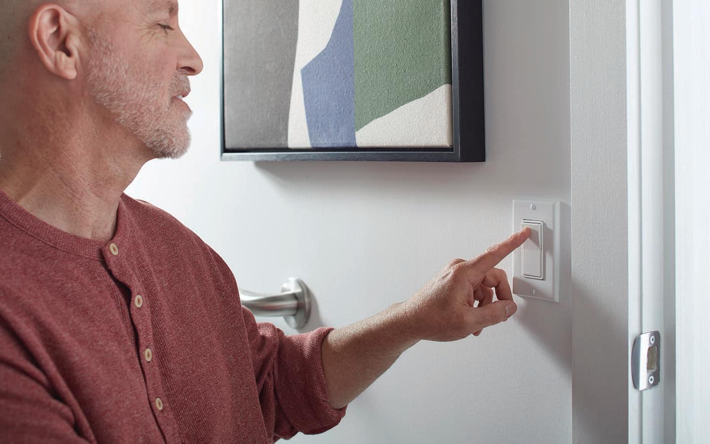 A person pushes a rocker switch. A person pushes a rocker switch.