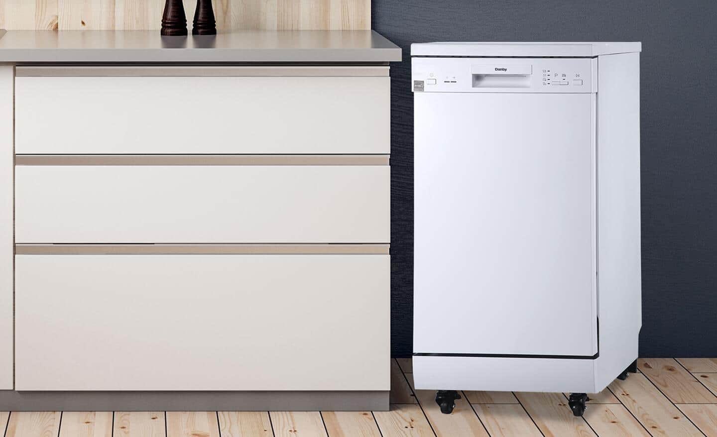 A portable dishwasher placed next to a kitchen counter.