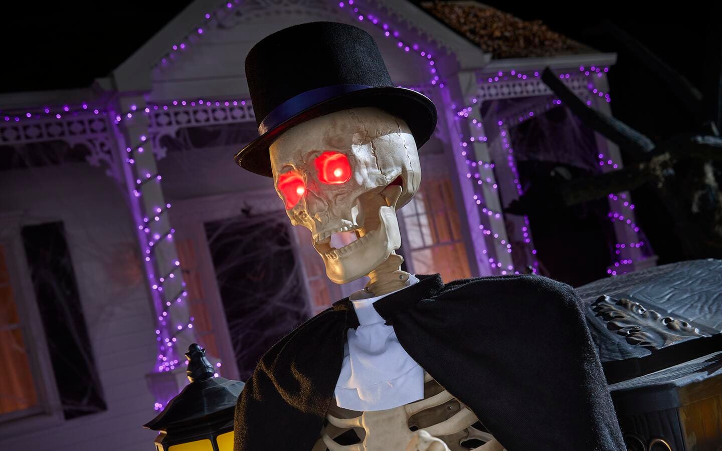 A front yard decorated with a skeleton and other Halloween decor. A front yard decorated with a skeleton and other Halloween decor.