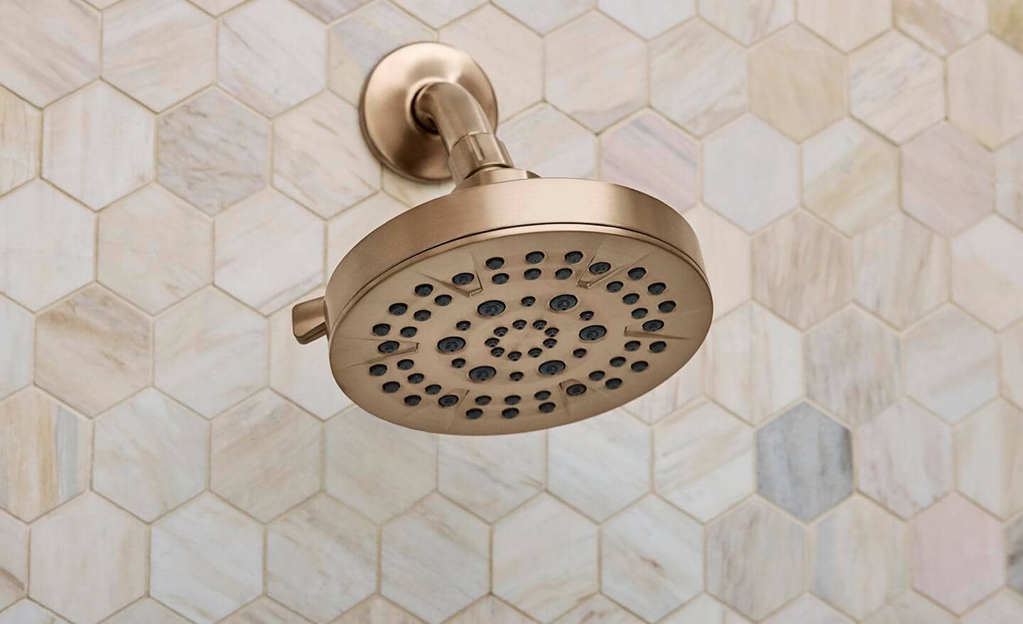 A copper-colored shower head. A copper-colored shower head.