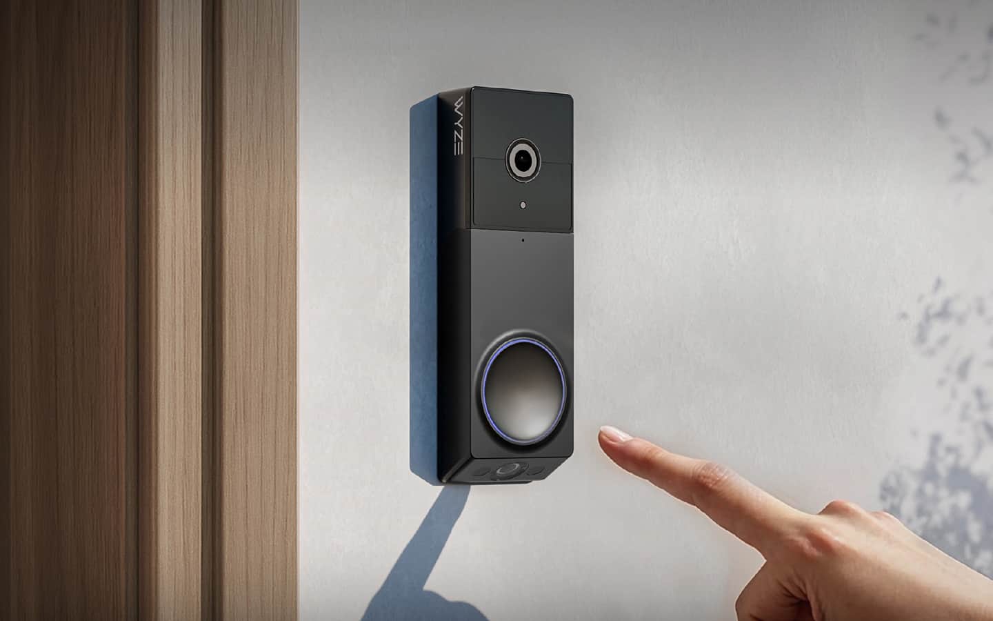 A person about to activate a smart doorbell with a camera. A person about to activate a smart doorbell with a camera.