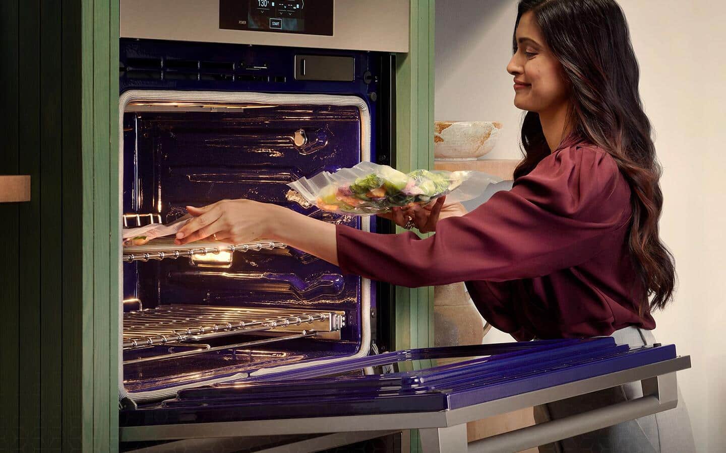 A woman using a smart range to cook different dishes. A woman using a smart range to cook different dishes.