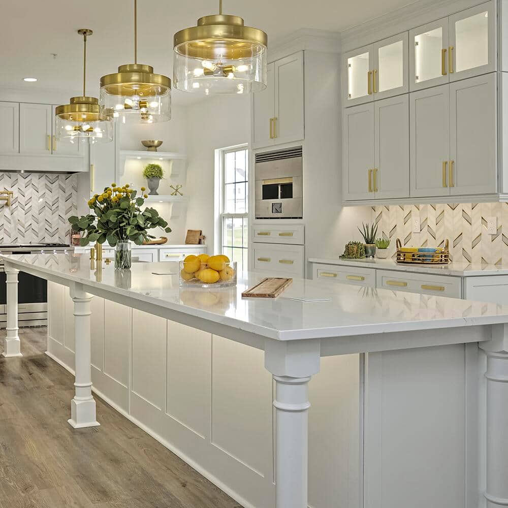 A kitchen beautifully lit with pendants and under cabinet lights.