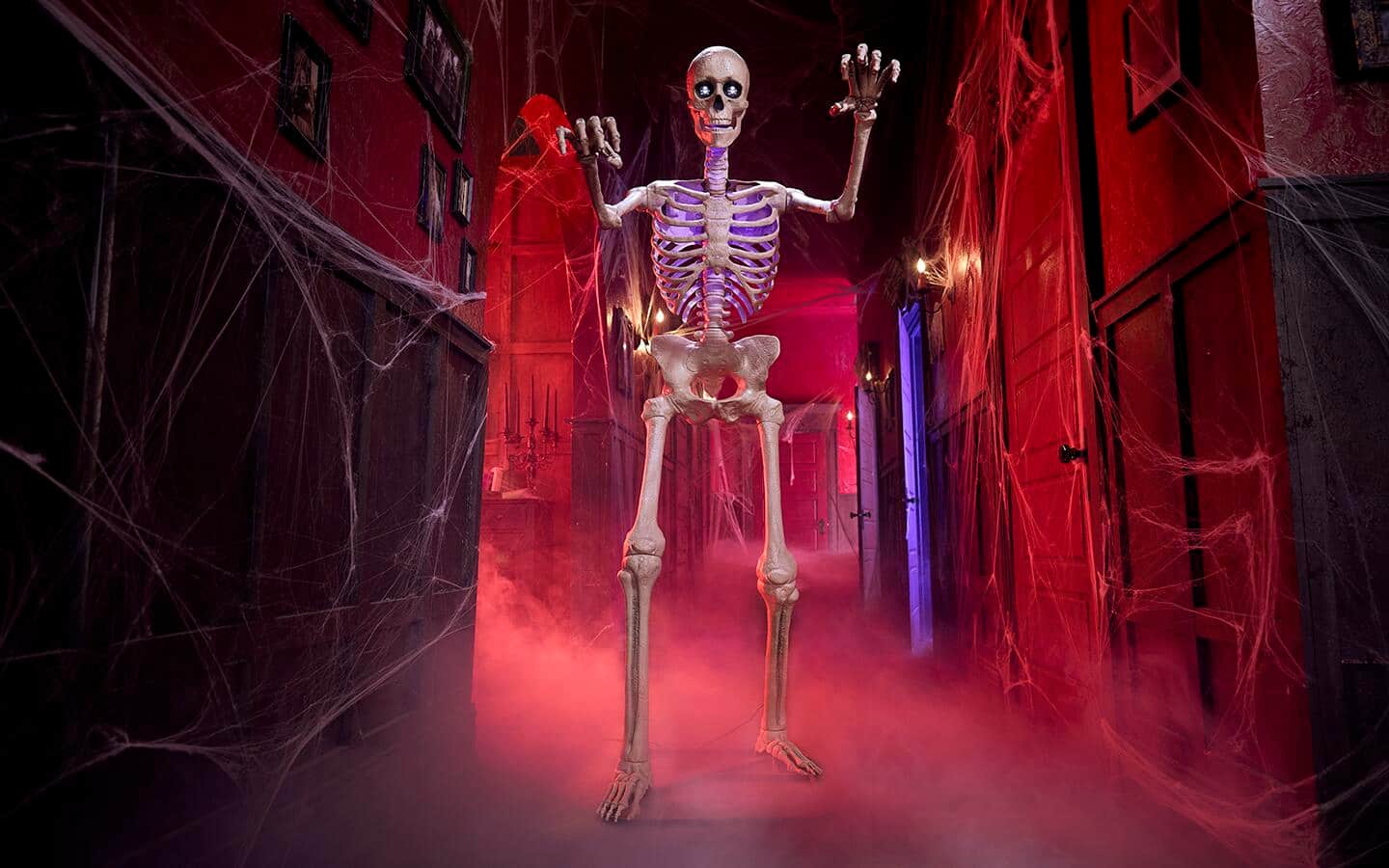 A 12-foot skeleton looms over a village flooded in blood-red lights. A 12-foot skeleton looms over a village flooded in blood-red lights.